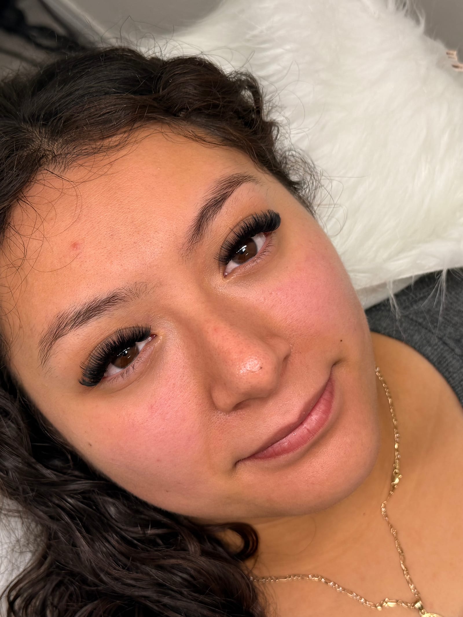 Reclining close-up highlighting a dimensional lash look.