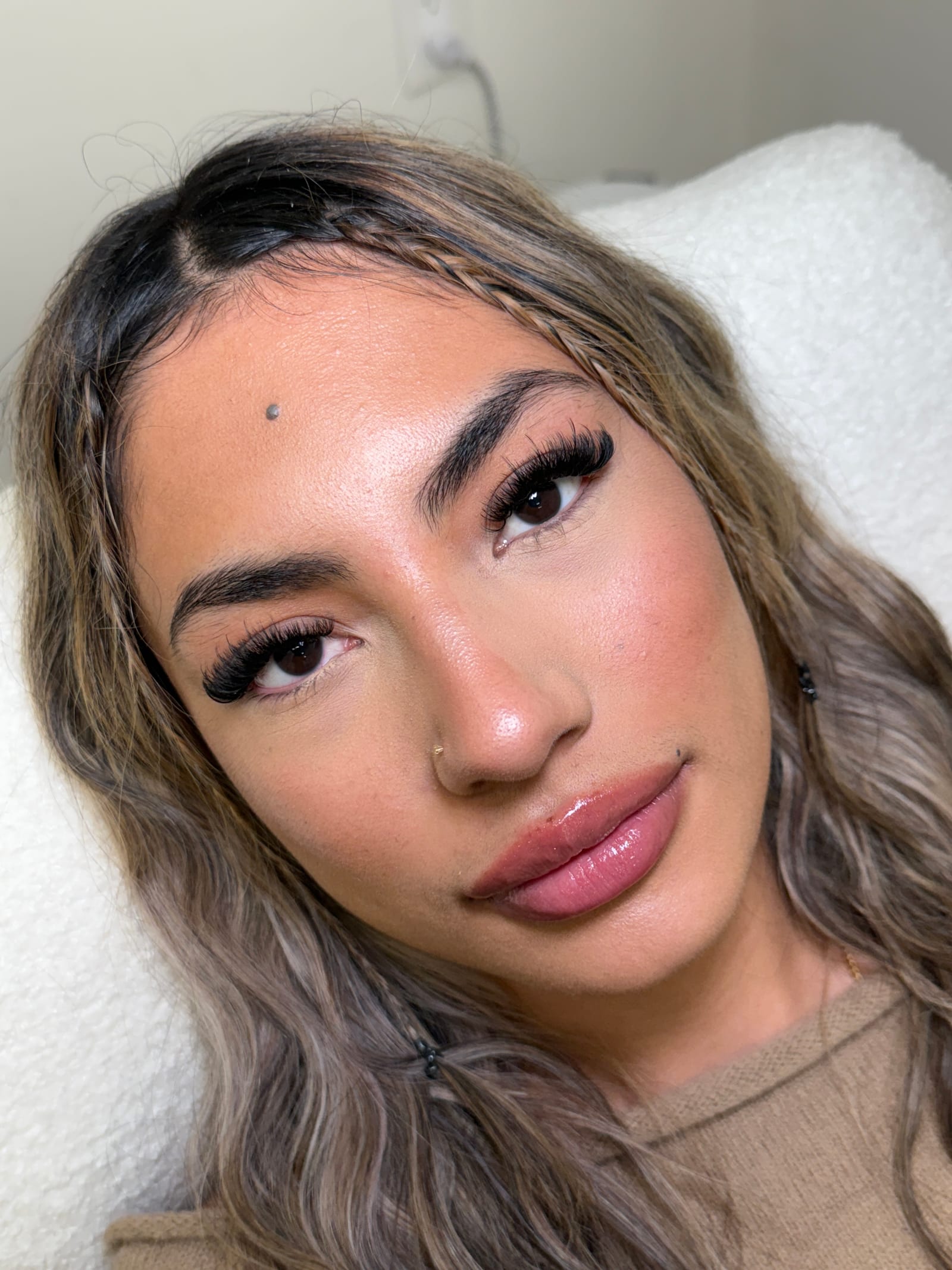 Close-up portrait highlighting a full, textured lash look.